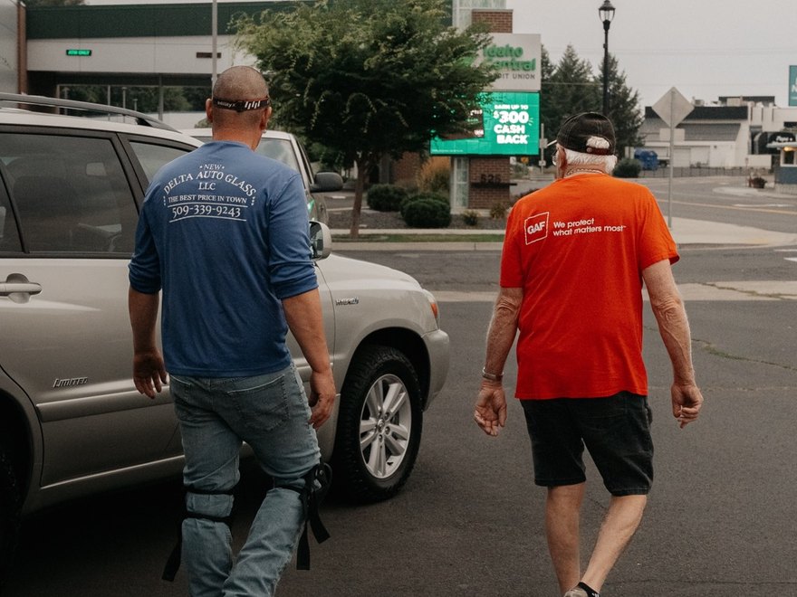 Victor of New Delta Auto Glass walking a customer to their car